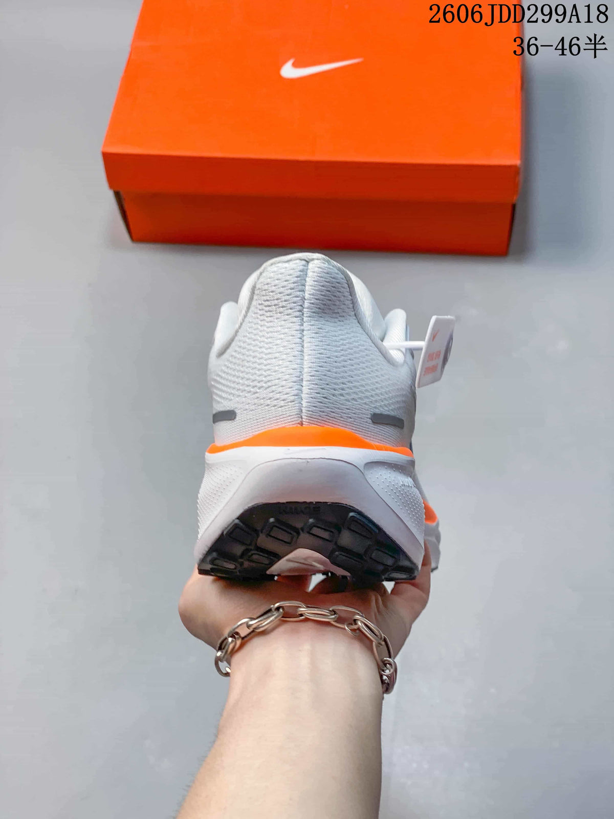 Rear view of the white Nike running shoe showing the heel and outsole.