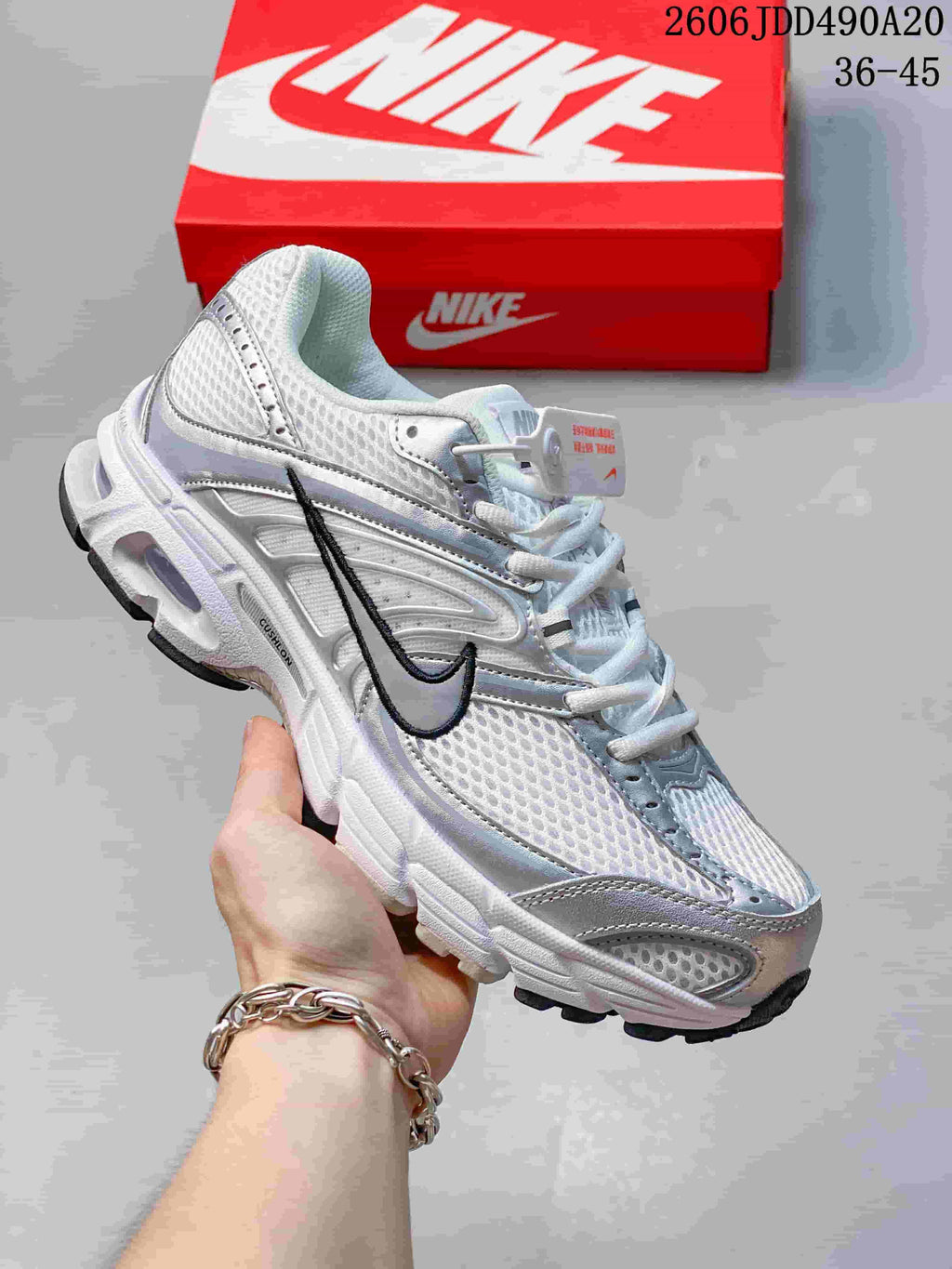 White and silver Nike Air Max Moto 2K sneaker with a black Swoosh