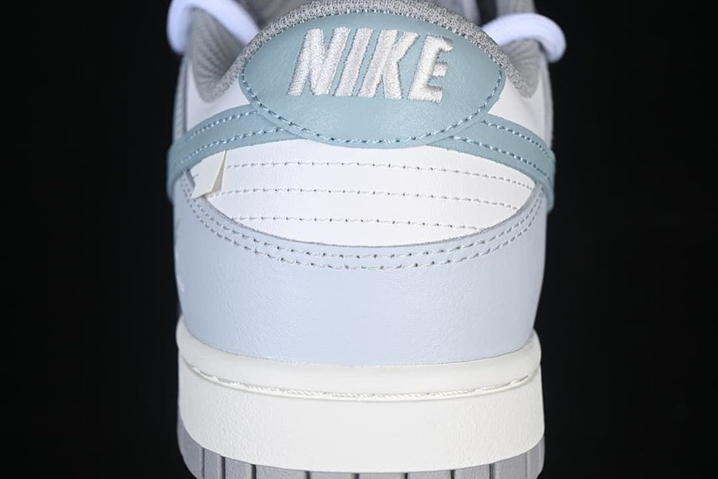 Rear view showing the blue heel panel and embroidered Nike lettering