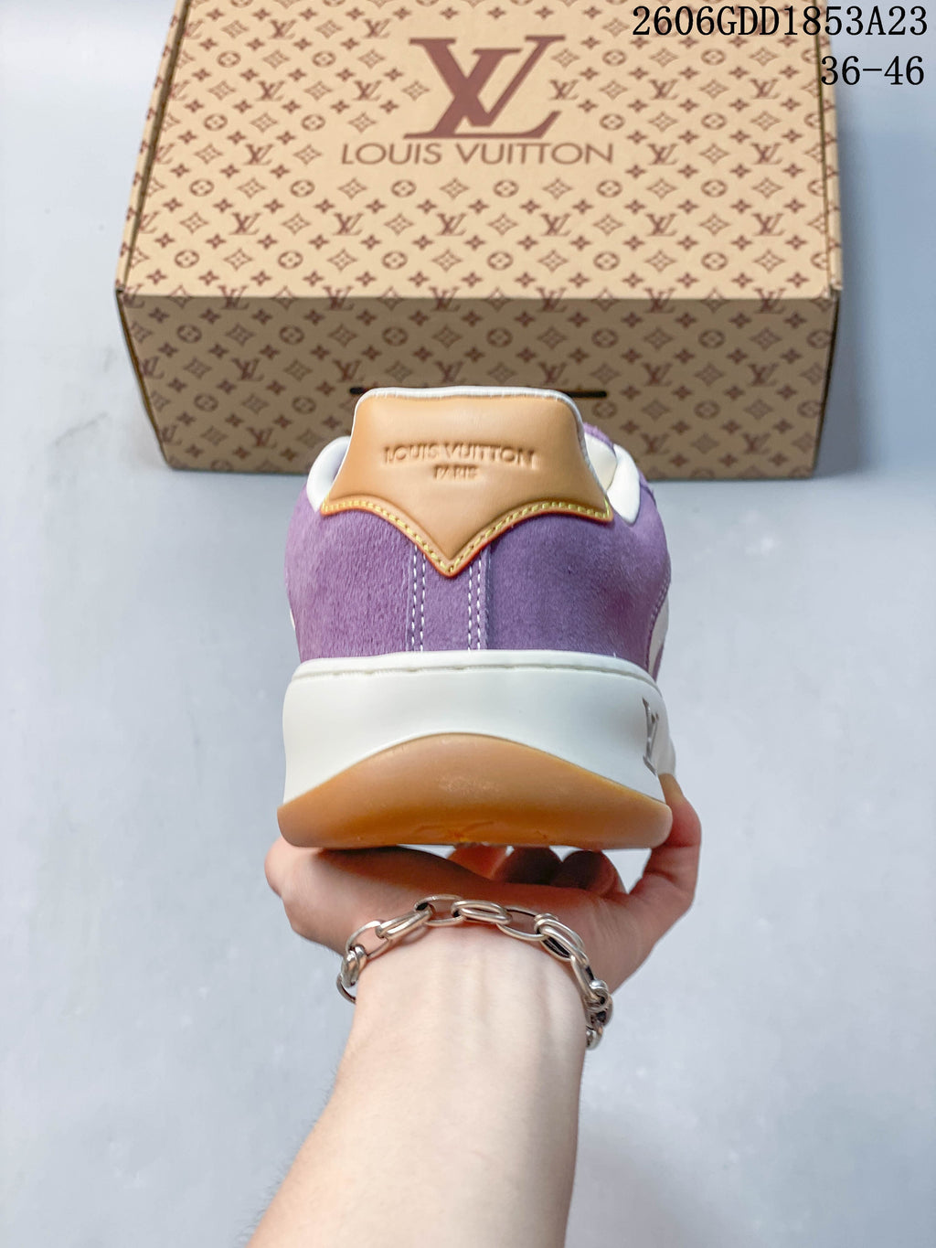 Rear view of the purple sneaker with tan heel detail and contrasting sole