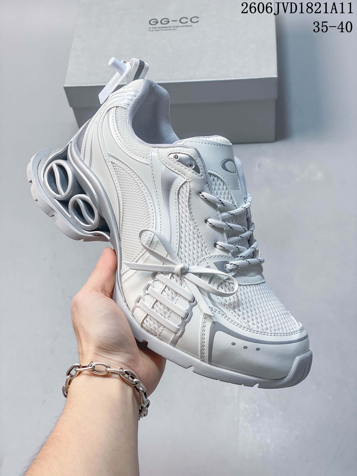 Side view of the white and silver-toned platform sneaker