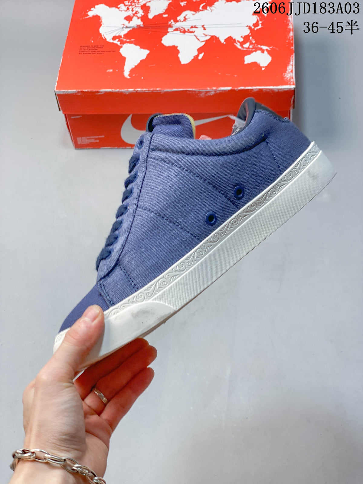 Side view of the blue sneaker with white patterned sole trim
