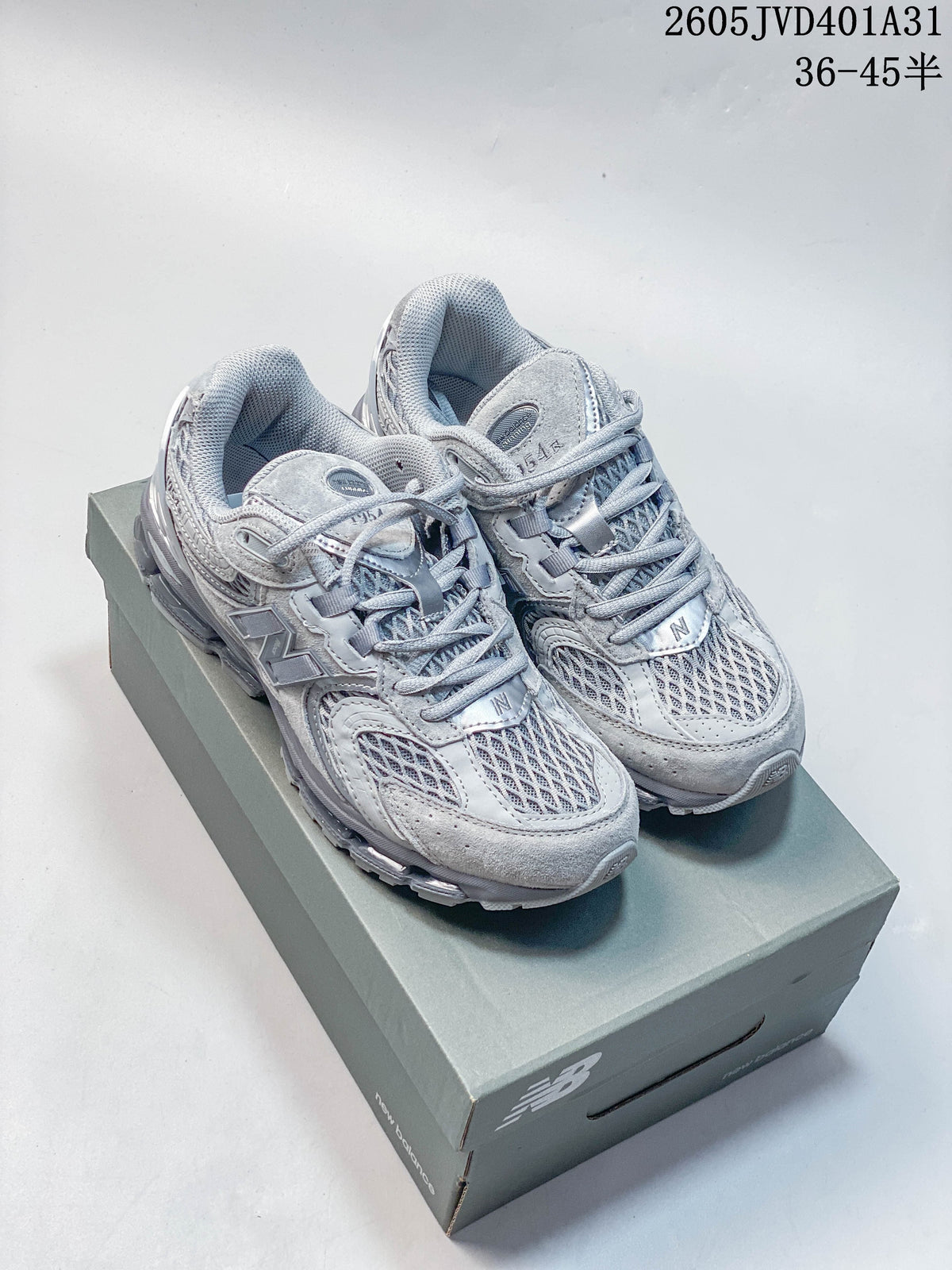 Light gray New Balance 997 sneakers photographed on a shoebox