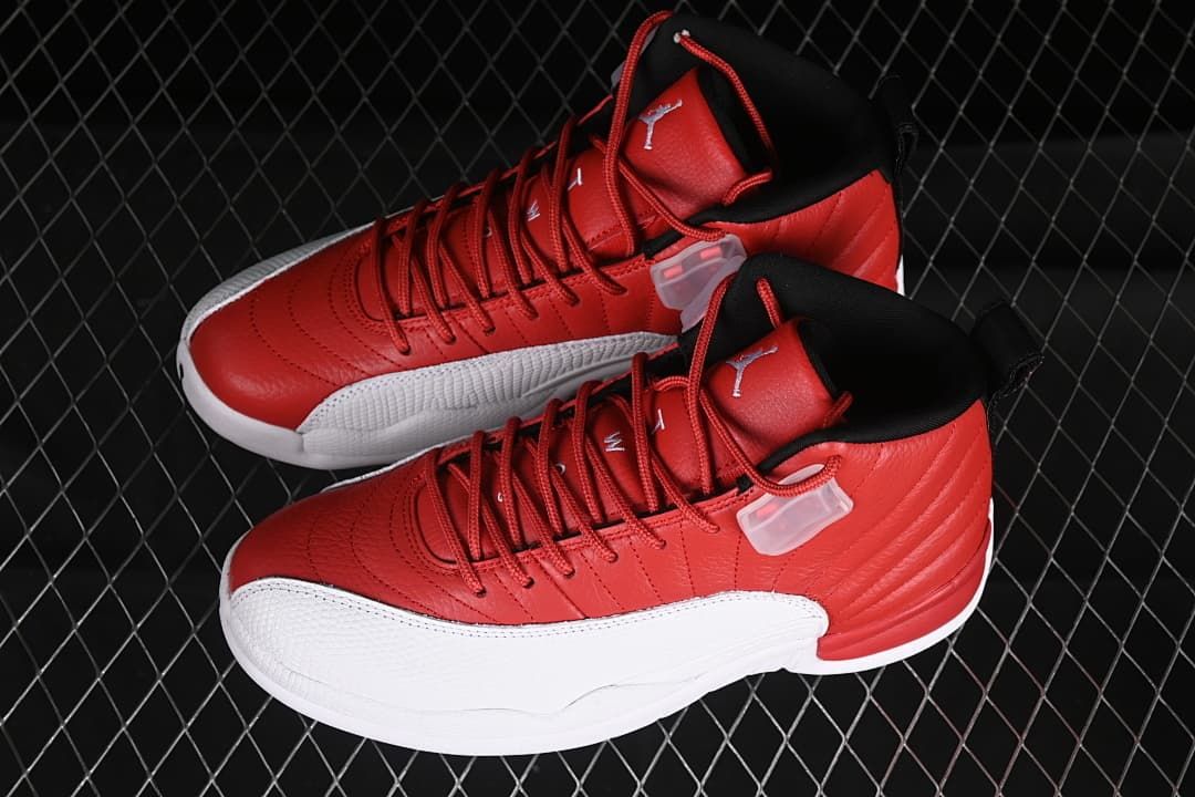 Pair of red, white, and black Air Jordan 12 sneakers