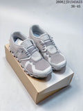 Pair of light gray On Cloudtilt Remix sneakers displayed on a shoebox