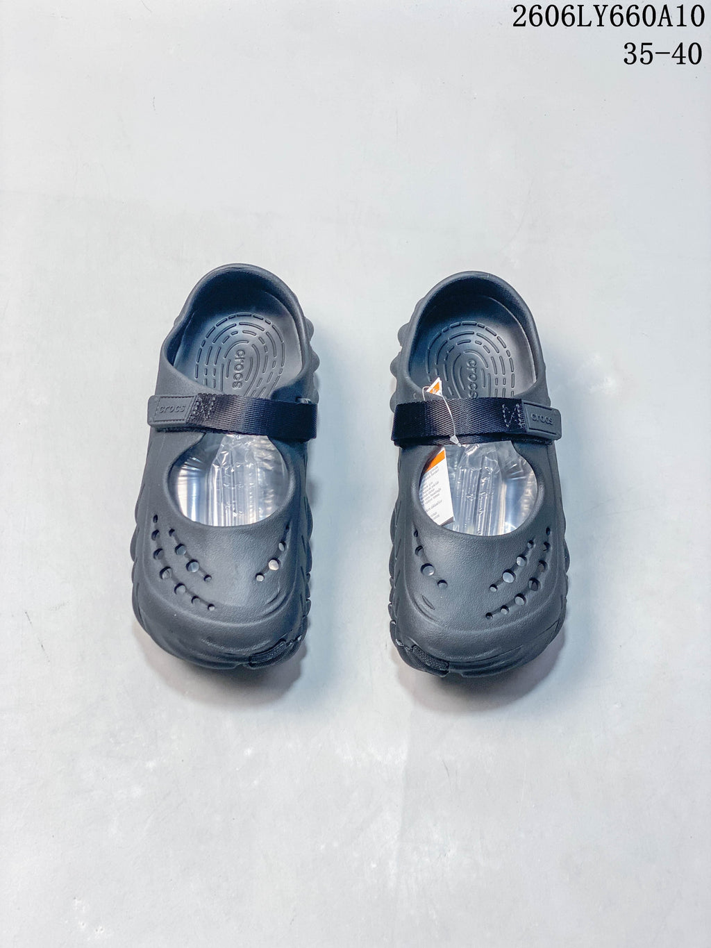Pair of dark navy Crocs Mary Jane-style clogs viewed from above, with perforated toes and instep straps.