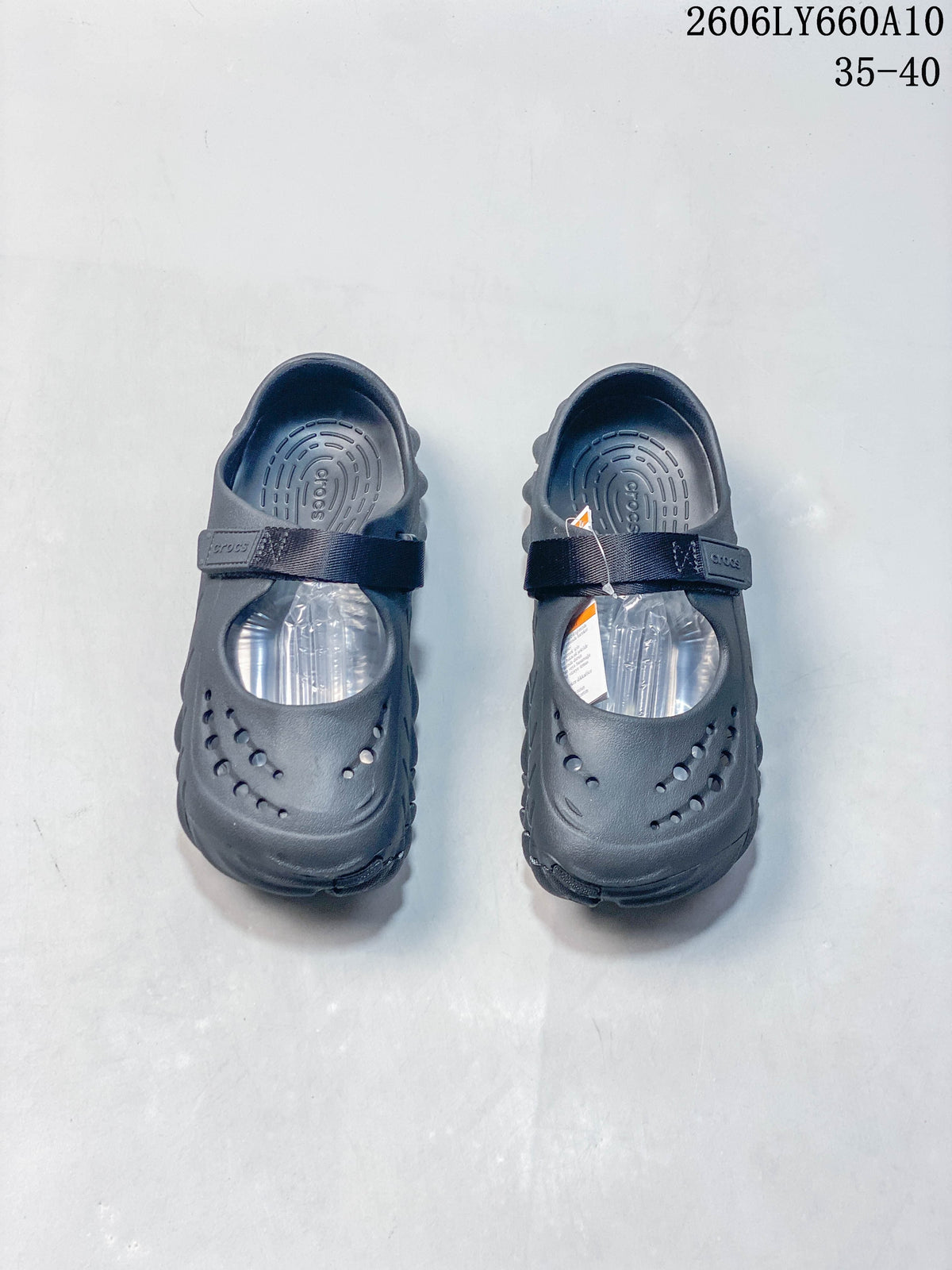 Pair of dark navy Crocs Mary Jane-style clogs viewed from above, with perforated toes and instep straps.