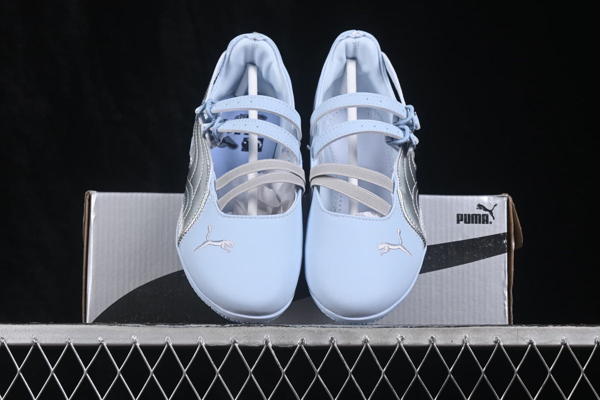 Front view of the pair displayed over a Puma shoe box.