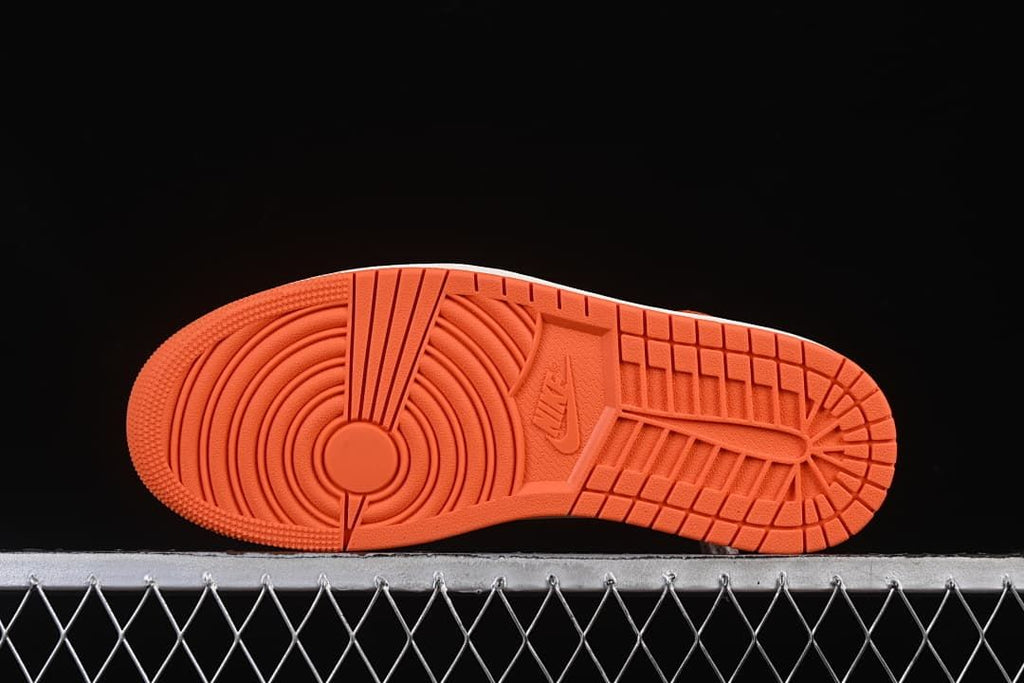 Orange outsole with circular and block-pattern tread