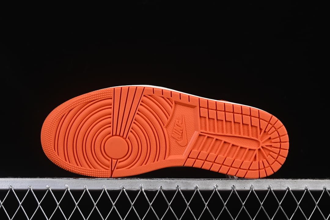 Orange outsole with circular and block-pattern tread