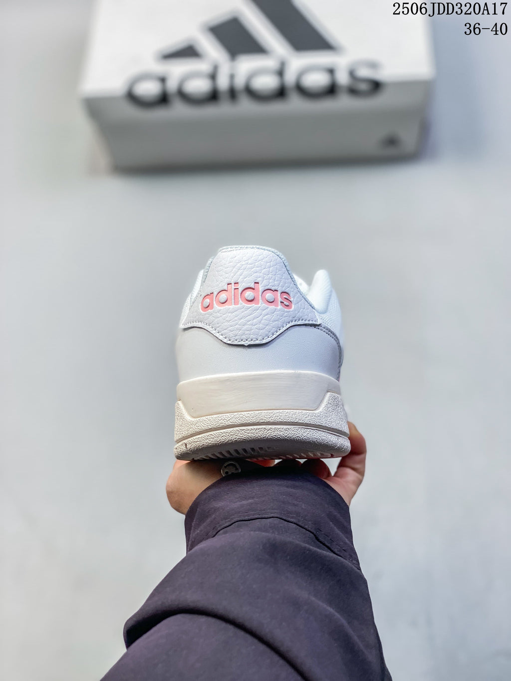 Rear view of a white adidas sneaker with pink heel branding