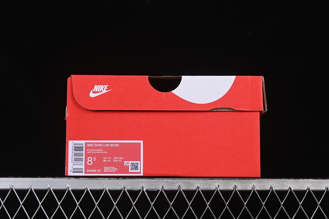 Red Nike shoe box with a label identifying Nike Dunk Low Retro and sample size EU 42