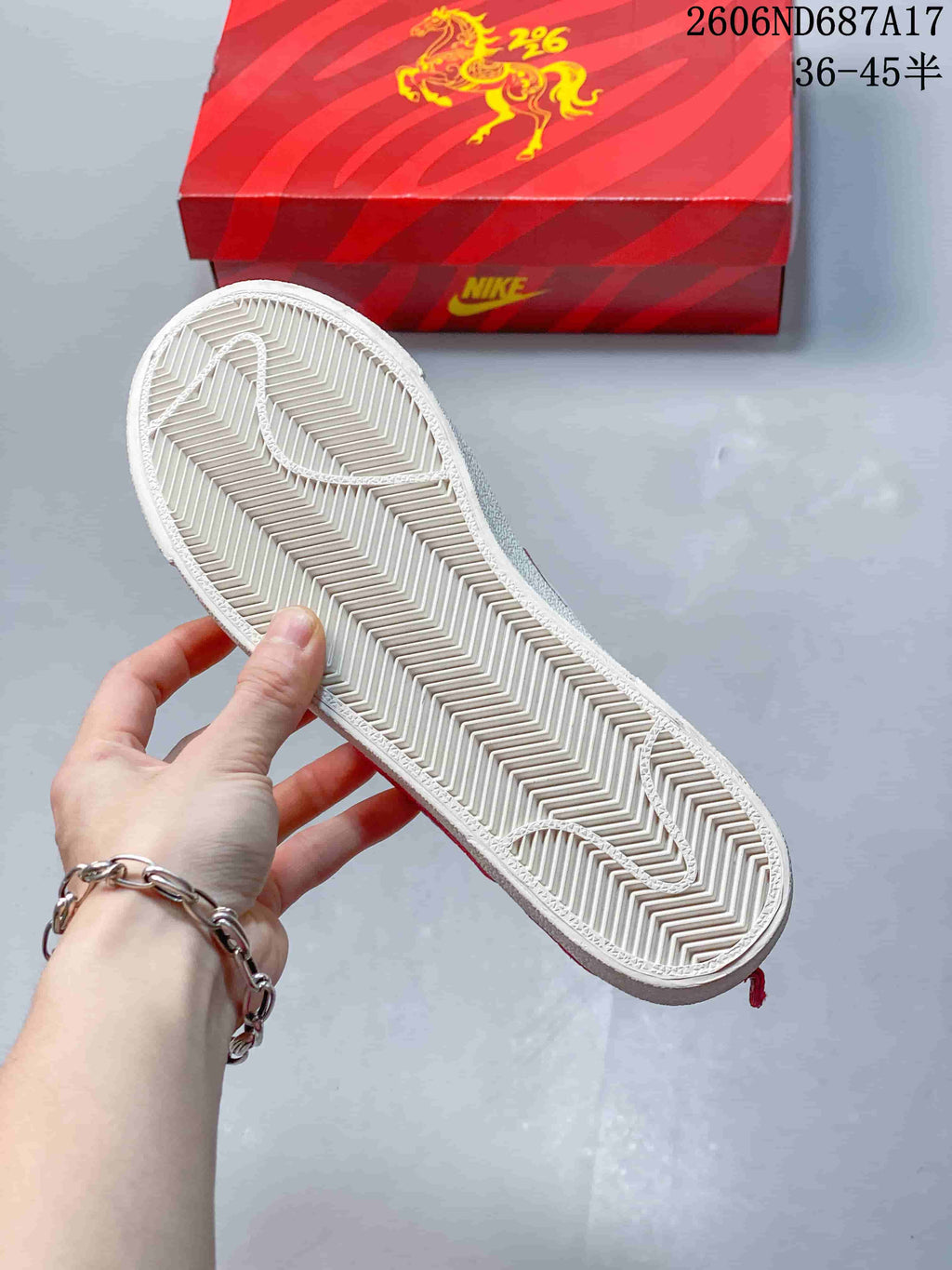 Close-up of the sneakers' white outsole with a herringbone tread pattern.