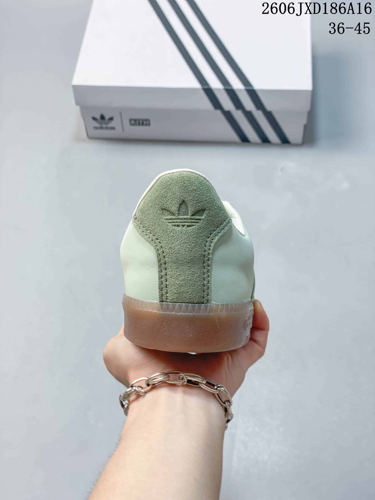 Rear view of a pale green sneaker with a darker green heel panel and gum-colored sole.