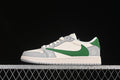 Side view of a grey, white, and green low-top sneaker