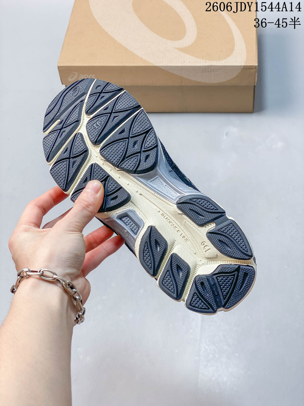 Close-up of the patterned outsole on a navy and gray sneaker