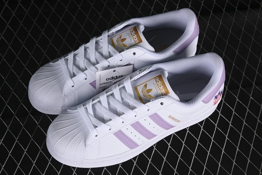 Pair of white and lavender Superstar sneakers shown from above