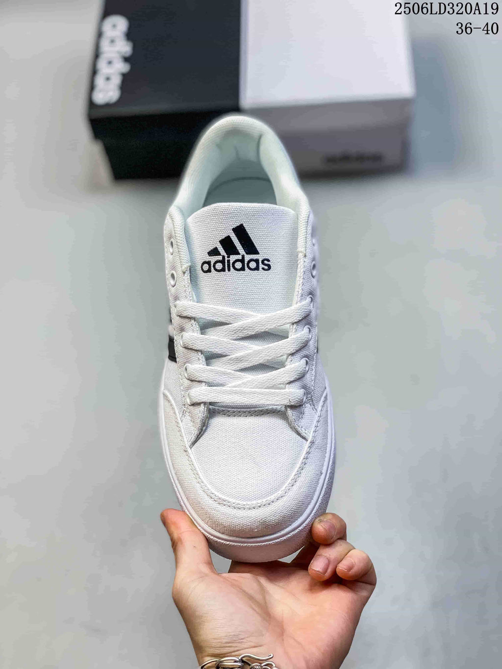 Top view of the white sneaker showing its laces, toe, and tongue logo.