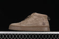 Side profile of a khaki Timberland-branded mid-top lace-up boot
