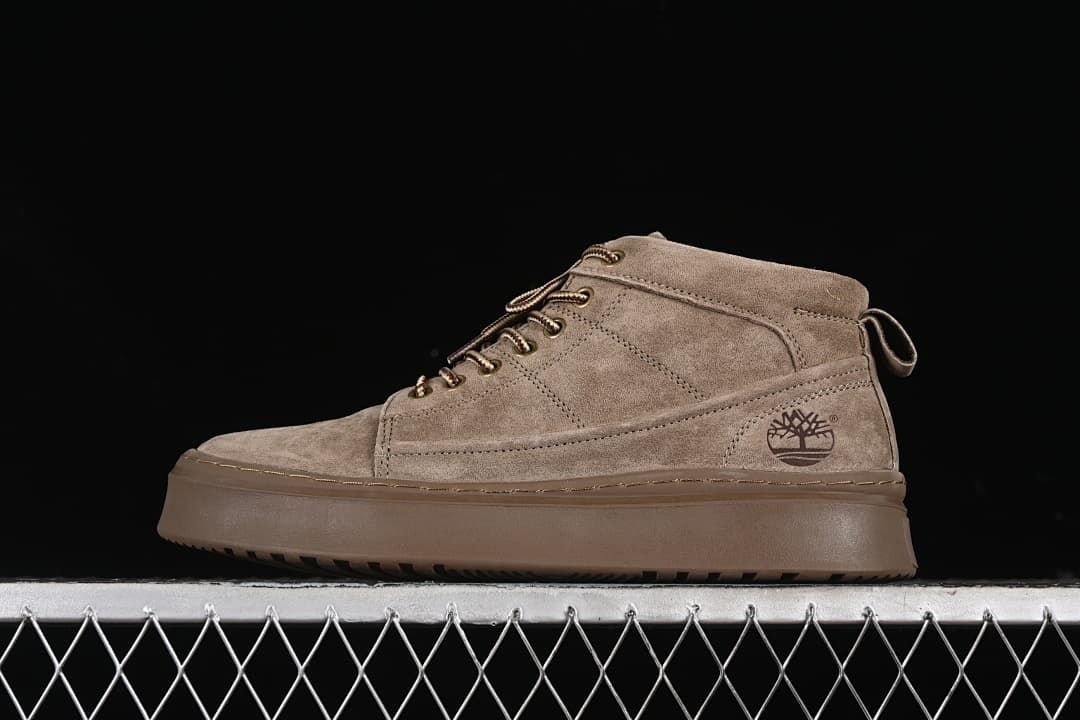 Side profile of a khaki Timberland-branded mid-top lace-up boot