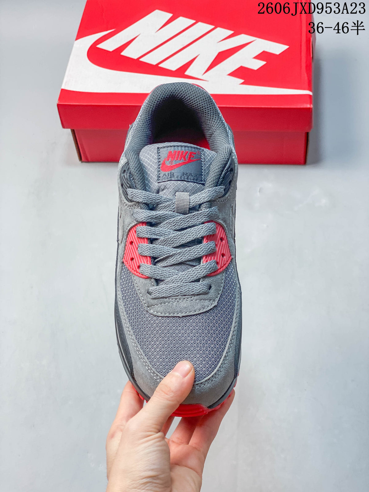 Top view of a gray and red Nike Air Max 90 sneaker