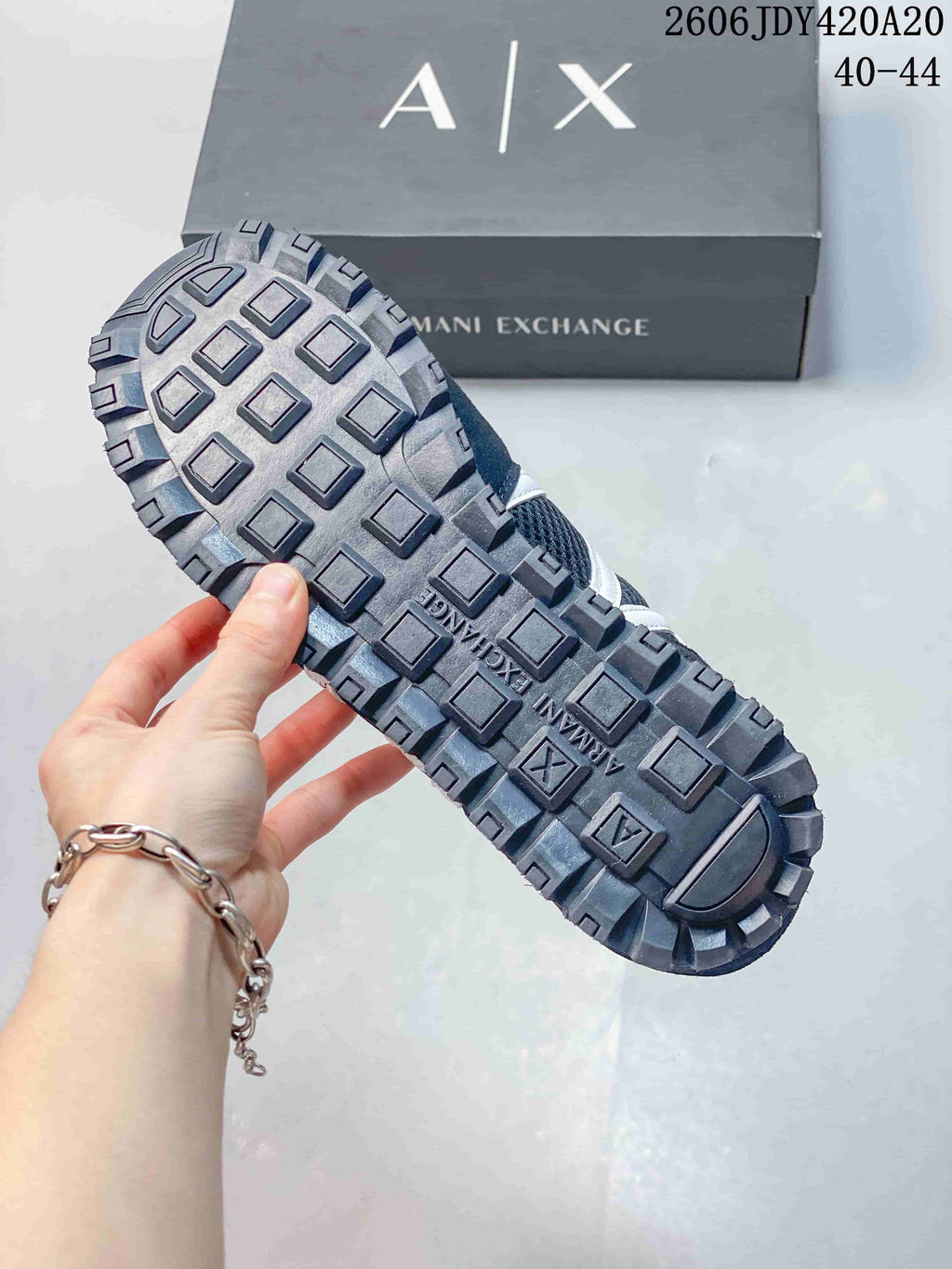 Close-up of the patterned outsole on a navy sneaker