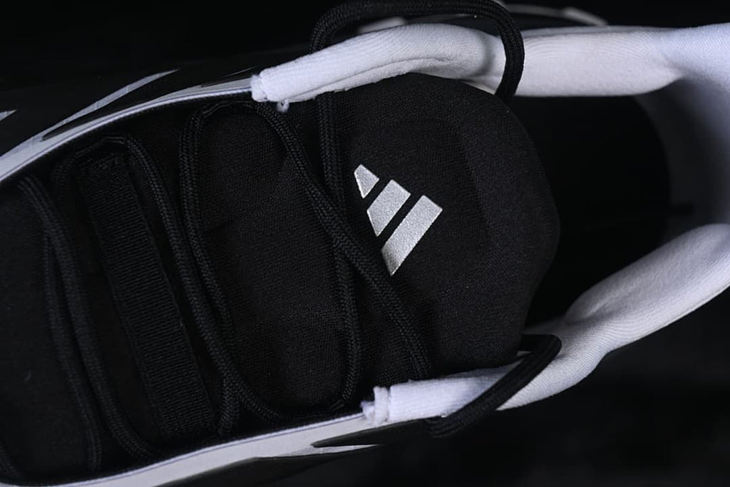 Close-up of the black tongue and Adidas logo
