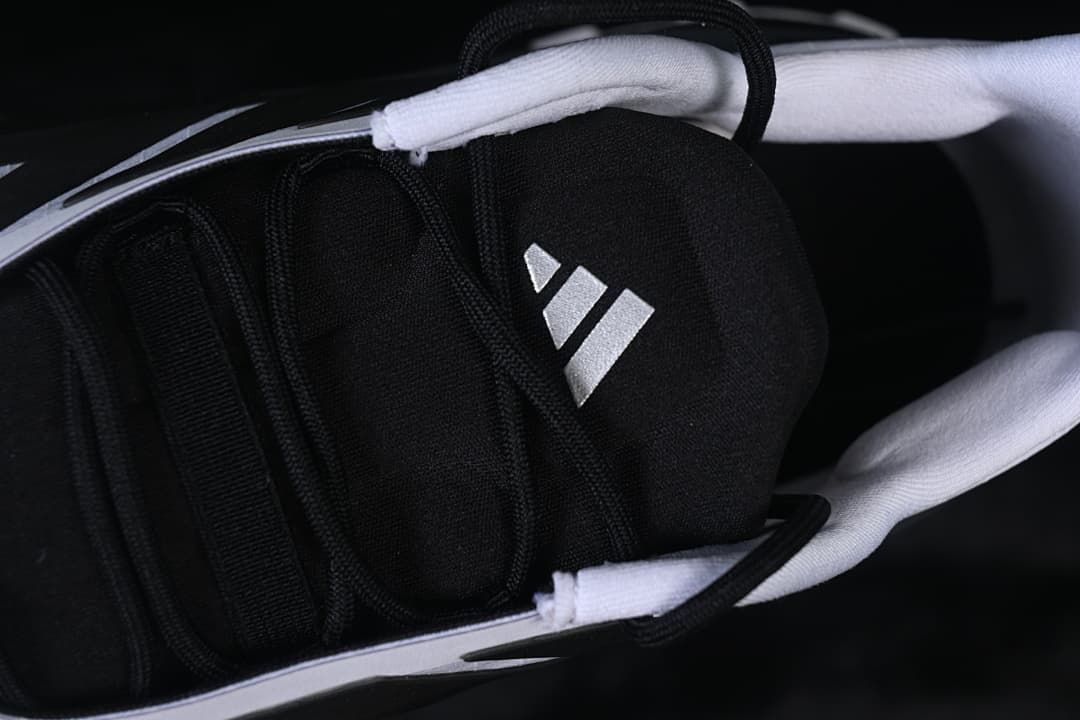 Close-up of the black tongue and Adidas logo