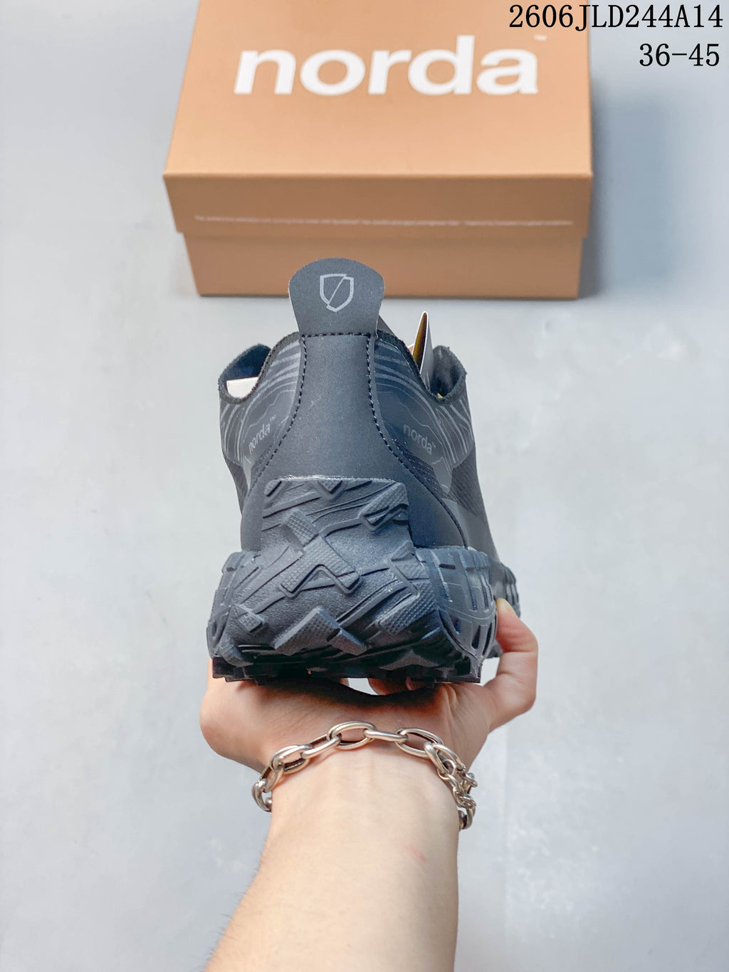 Rear view of the black norda shoe showing the heel pull tab and textured outsole.