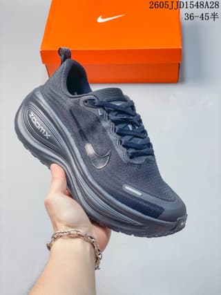 Dark charcoal Nike Vomero Plus shoe with tonal details and a dark layered sole.