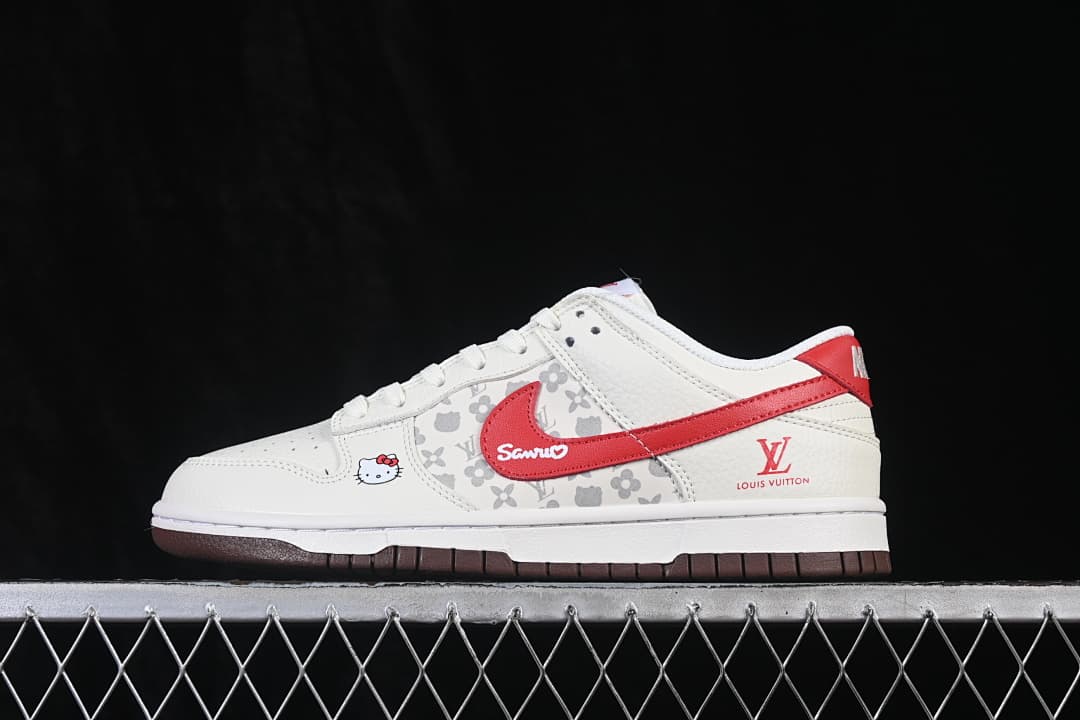 Side view of a cream low-top sneaker with a red accent, patterned side panel, character graphic, and dark brown outsole.