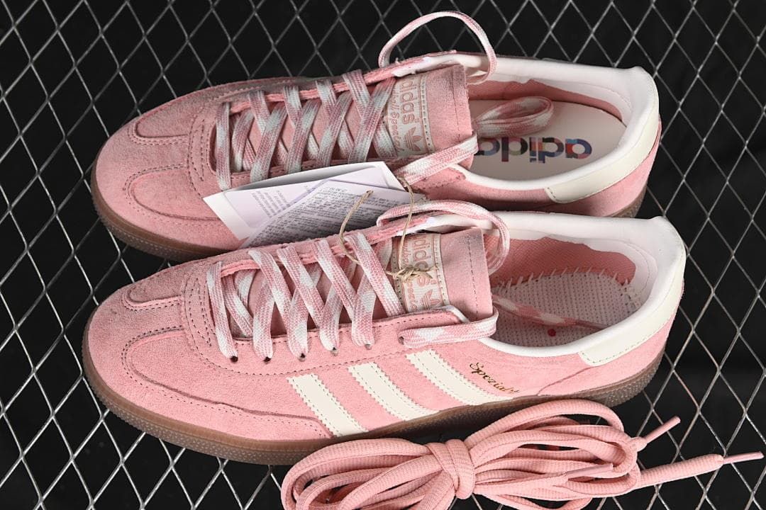 Pair of pink and off-white Handball Spezial sneakers with an extra set of pink laces