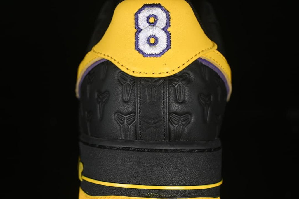 Rear view showing yellow heel panels and embroidered number 8 detail.