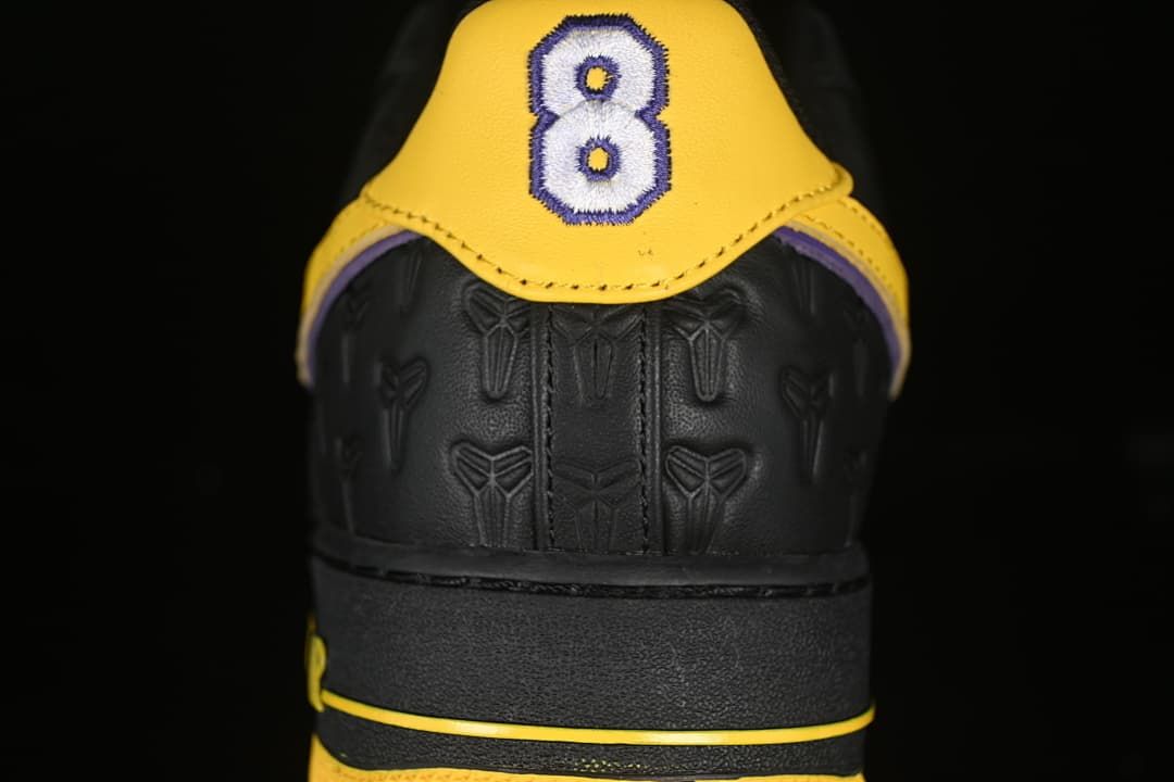 Rear view showing yellow heel panels and embroidered number 8 detail.