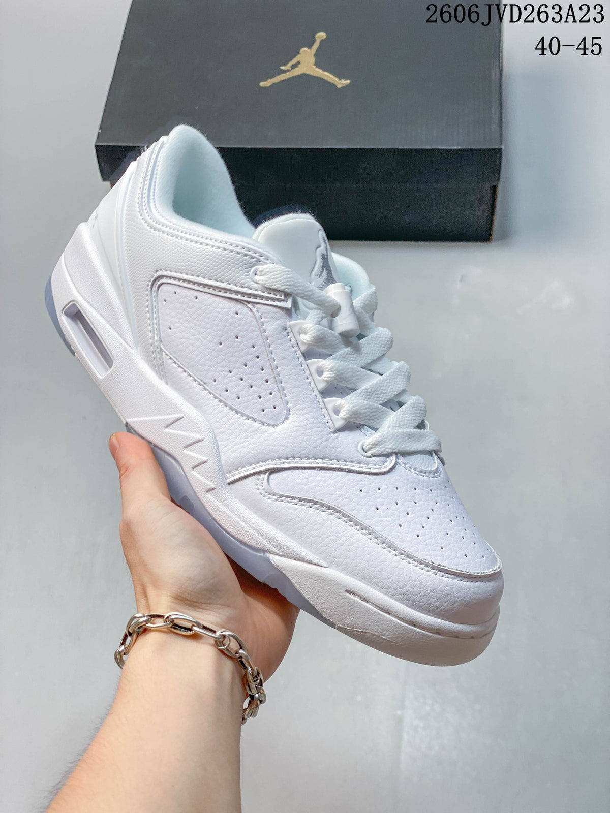 Angled side view of a white low-top sneaker