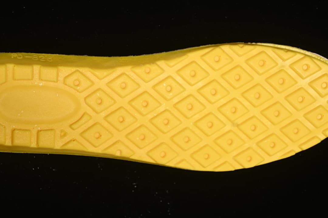 Close-up of the boot's yellow-toned outsole and patterned tread