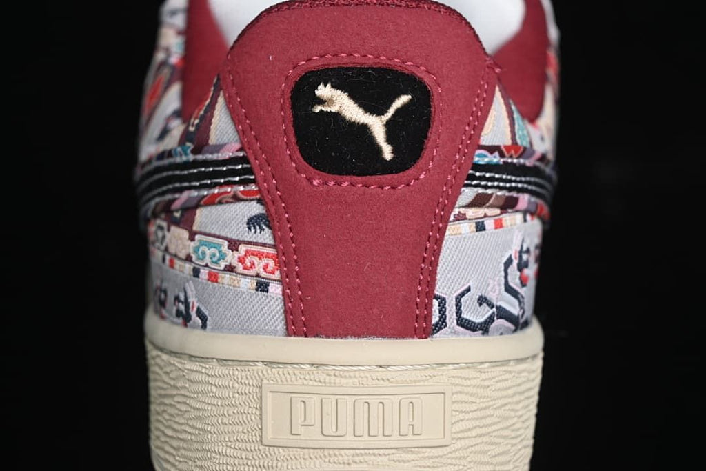 Rear view showing the patterned upper, burgundy heel panel, and cream sole