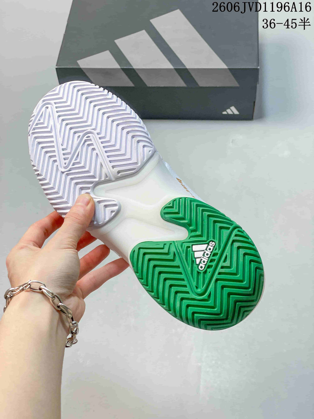 Underside of the tennis shoe showing a white and green patterned outsole.