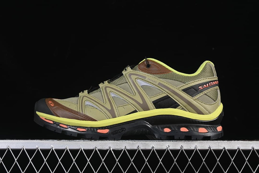 Side view of olive-toned Salomon XT-Quest trail shoes with brown, black, bright yellow, and coral accents.