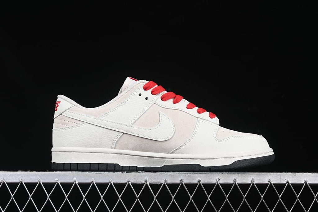 Side profile showing the off-white and beige upper with red laces