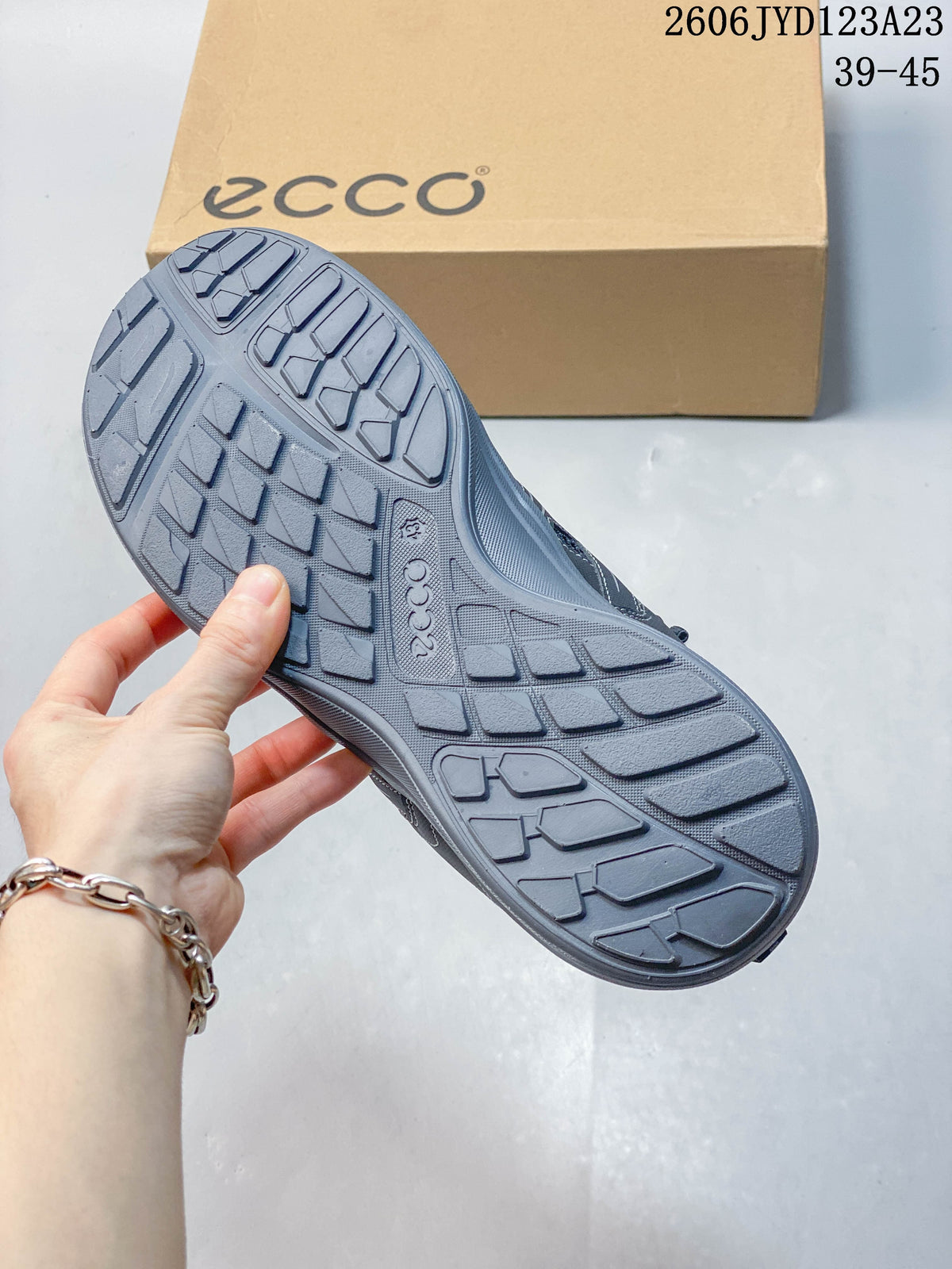 Close-up of the gray shoe outsole showing its patterned tread