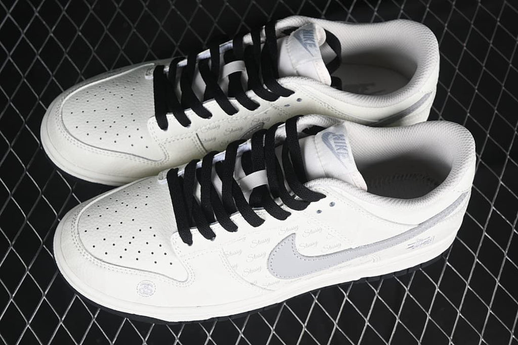 Pair of white and grey low-top sneakers viewed from above.