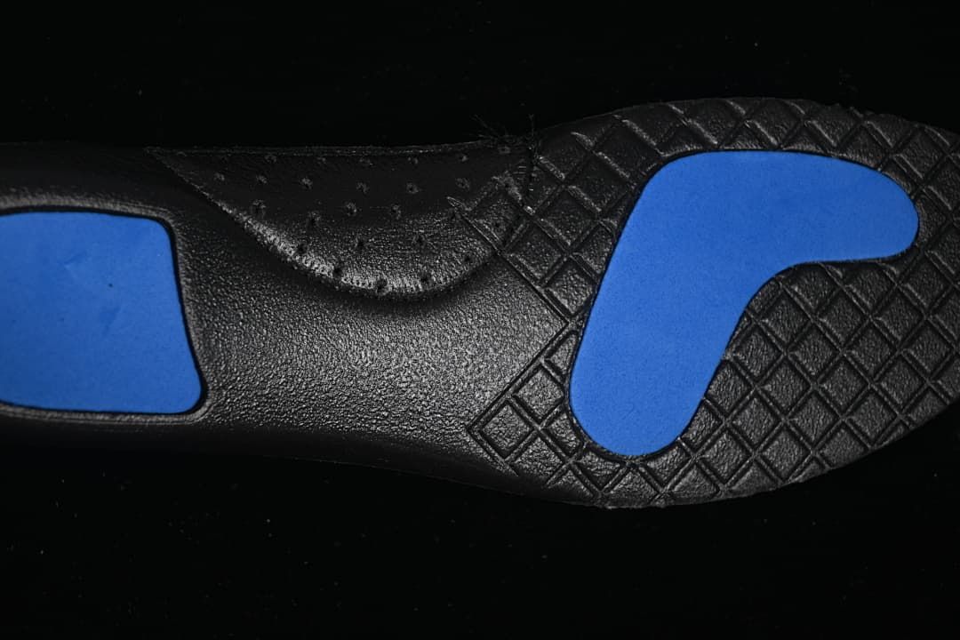 Close-up of the black outsole with blue inserts