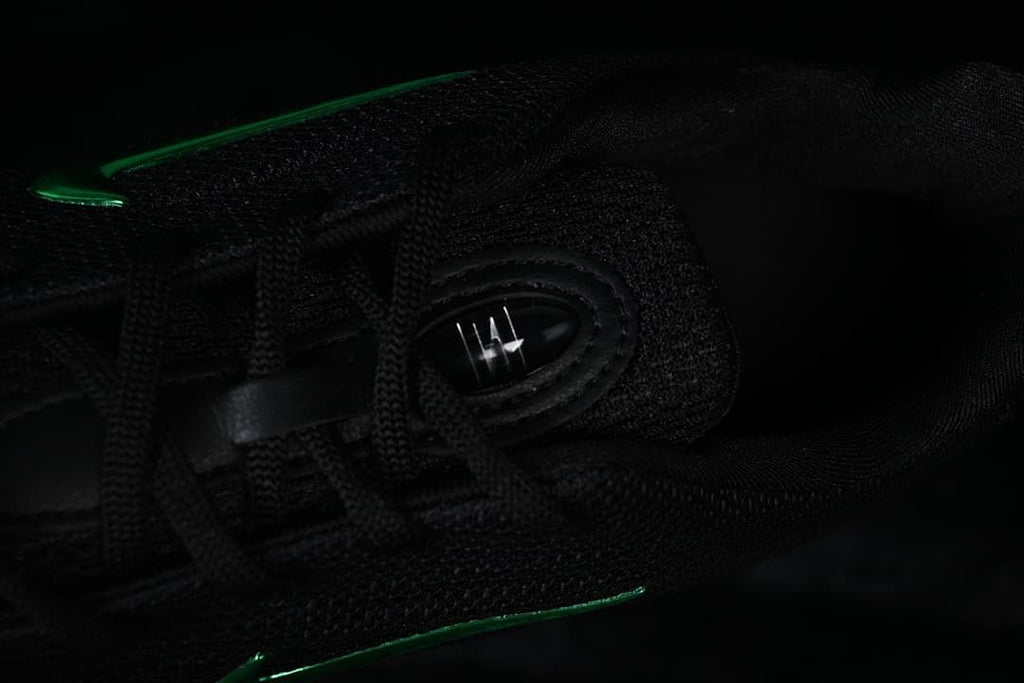 Close-up of black laces and tongue detail on the sneaker.