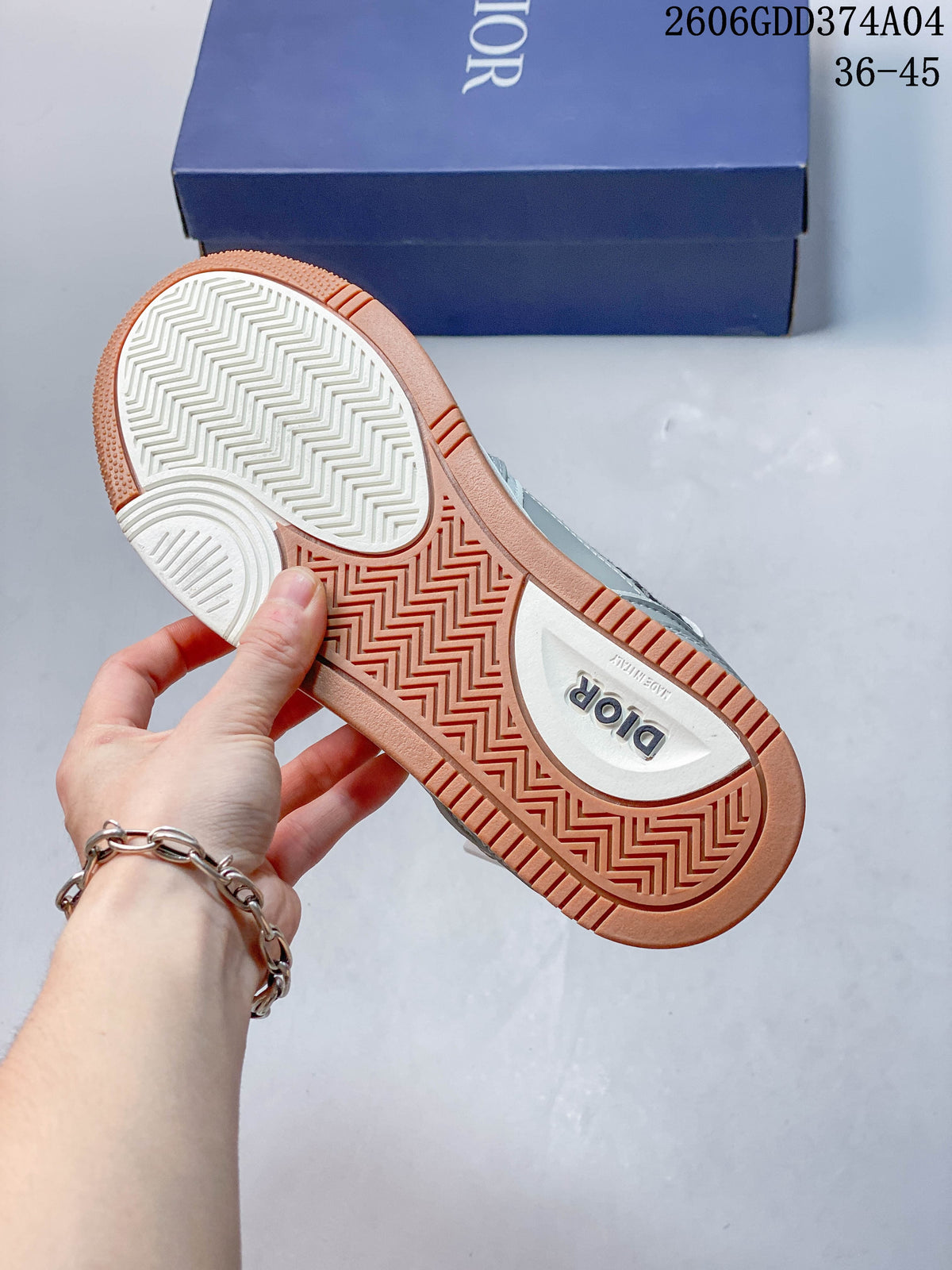 Underside of the sneakers showing a white and gum-colored patterned outsole