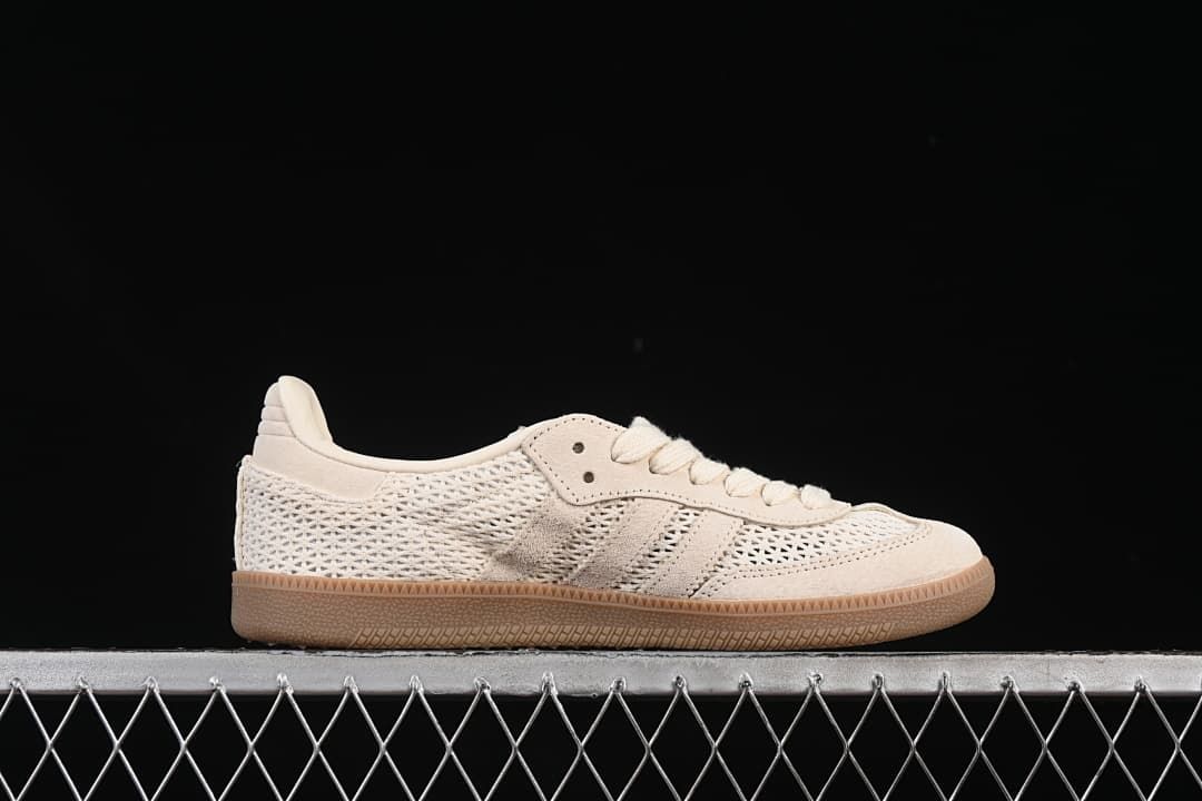 Side profile of the cream low-top sneaker with three side stripes and gum-tone outsole.