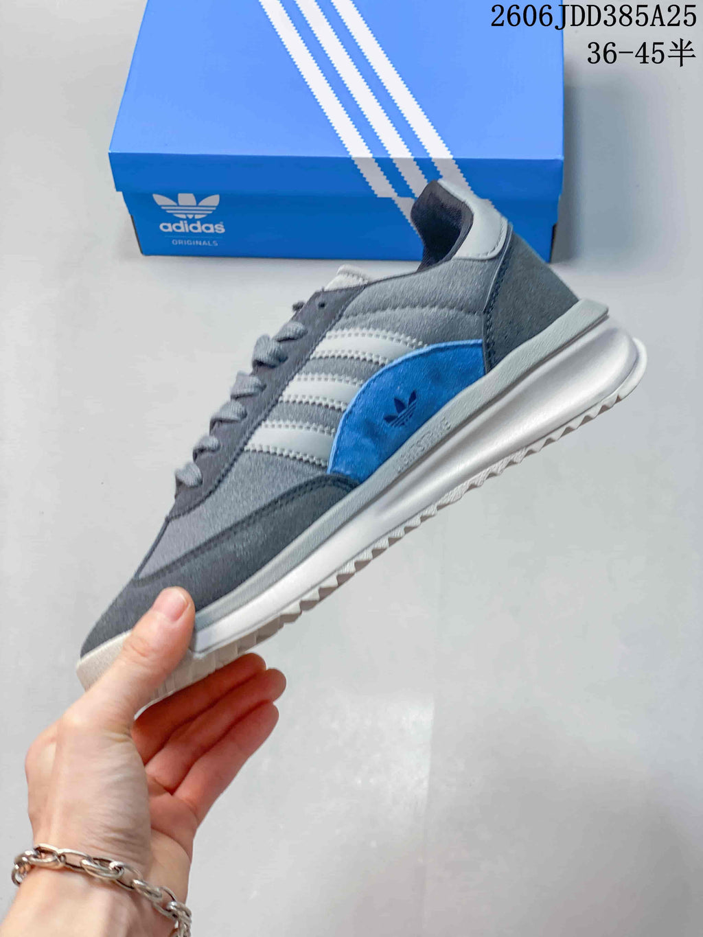 Side view of the adidas SL 72 sneaker with grey panels and a blue accent