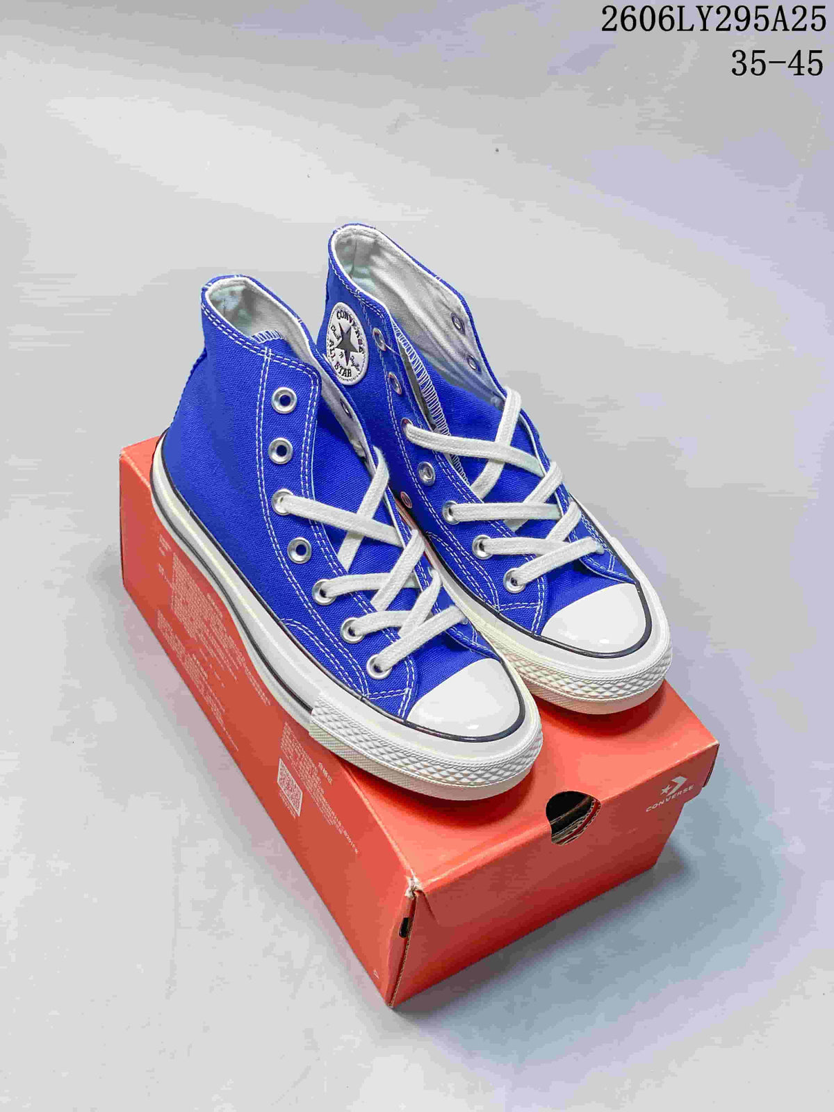 Pair of blue Converse Chuck Taylor All Star high-top sneakers with white laces and toe caps