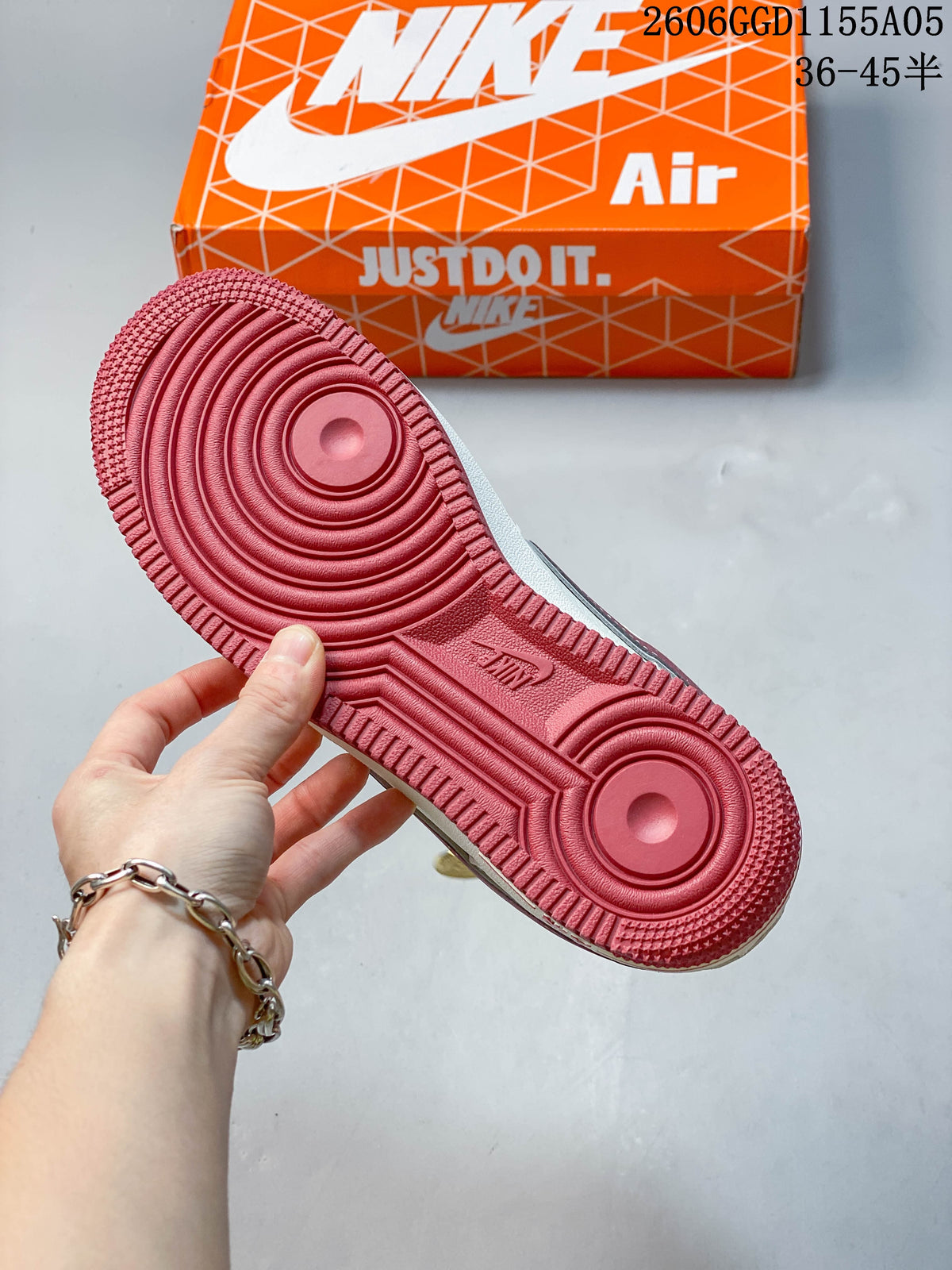 Close-up of the burgundy-red circular tread on the sneaker outsole