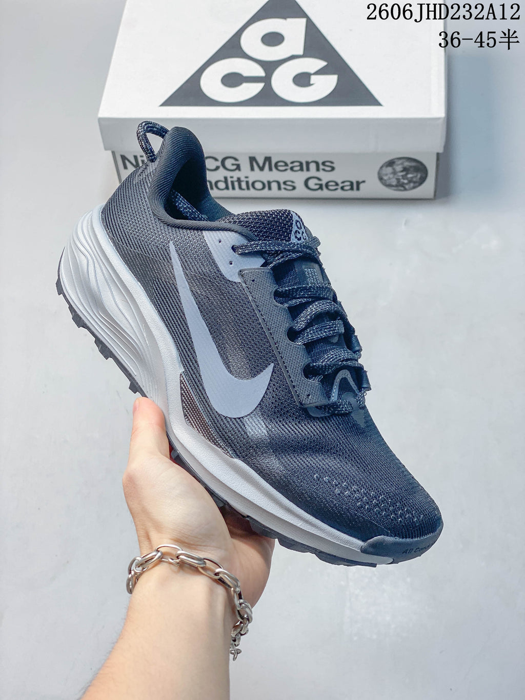 Side view of a single dark gray-blue Nike ACG Pegasus Trail shoe